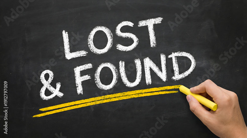 Fotografija Hand writing Lost and Found on blackboard with yellow chalk
