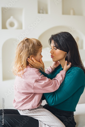 Mother and child share a moment in a cozy indoor setting