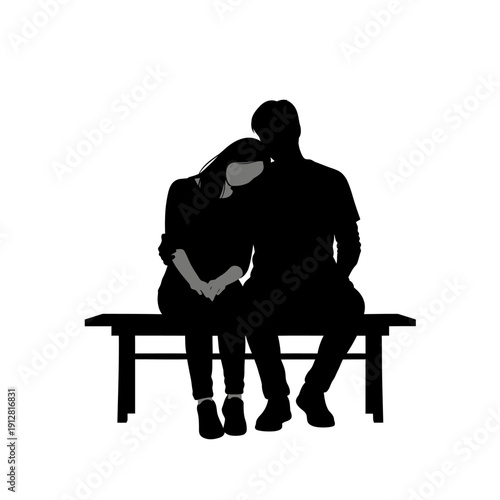 Silhouetted couple embracing on a park bench intimate moment