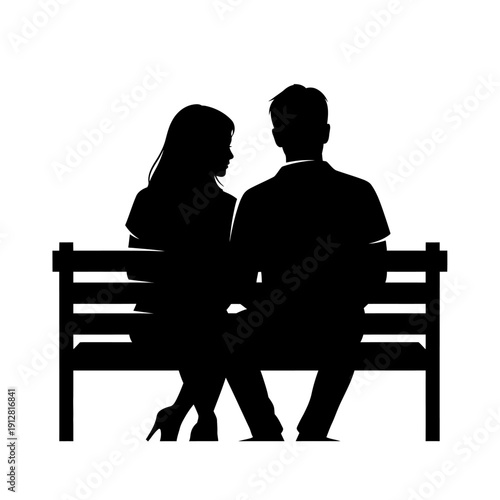 Silhouette of a couple seated closely together on a park bench