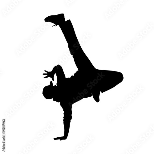 Silhouette of a breakdancer performing a dynamic handstand pose