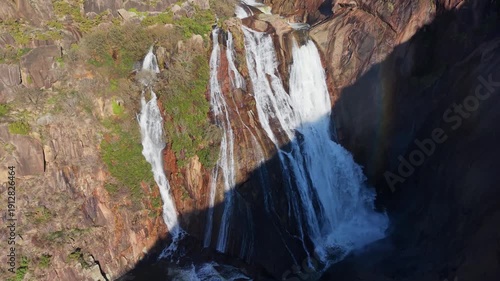 Ezaro Waterfalls Flowing Down The Rocky Cliffs In Dumbria, A Coruña, Spain. - aerial shot