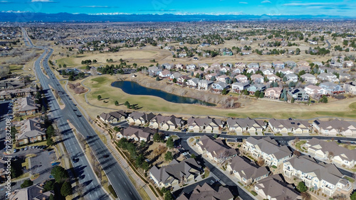 Homes surrounding Saddle Rock Golf Course extend toward E Arapahoe Rd with clear fairway boundaries. Light roofing, dormant greens, scattered trees create calm seasonal patterns, Aurora, CO