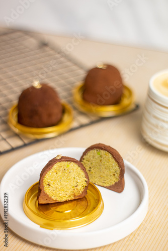 Принти на полотні Close up of Dubai Chewy Cookie sliced, showing a rich pistachio and kataifi filling inside, coated with coated powder and served on elegant gold base