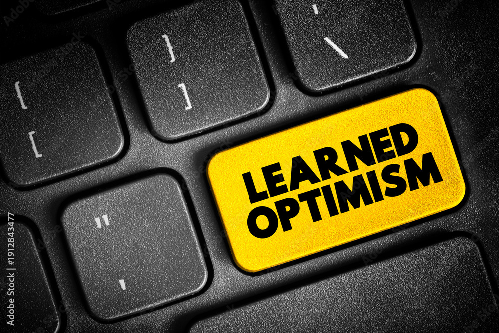 Fototapeta premium Learned Optimism - developing the ability to view the world from a positive point of view, text button on keyboard, concept background