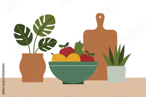 Kitchen countertop displays fresh fruit bowl, cutting board, and potted.