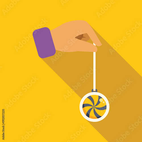 Hand holding a classic yo yo toy with spiral pattern against a yellow background