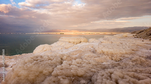 Wallpaper Mural Numerous  round salt mushrooms of the Dead Sea against backdrop of Jordan Mountains in rays of evening sun Torontodigital.ca