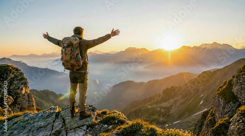 Sunrise hike in the mountains with a person standing on a rock looking at the view