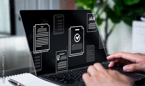 Foto Businessman checking digital documents on laptop for online document management, validation process, file processing, and organization of electronic document files