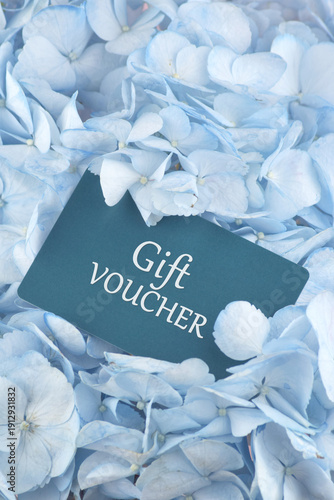 Blue Gift Card with flowers on a light background