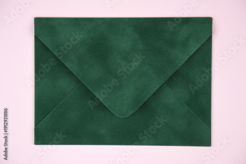 Gift voucher in a green envelope on a light background