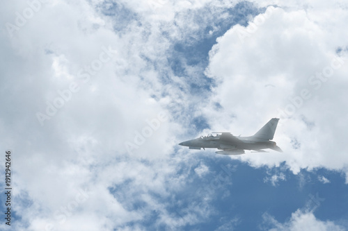 Fighter jet flies through the sky on technology background