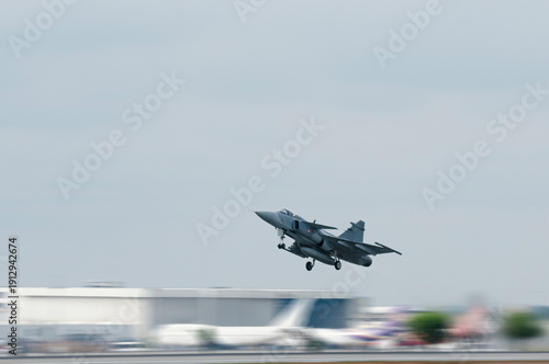 Supersonic fighter jet moving in airport on technology background