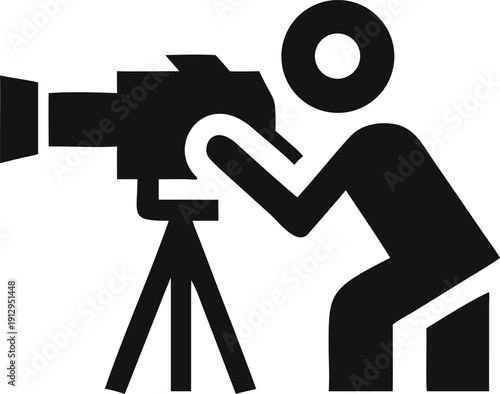 Professional videographer operating a large video camera on a tripod capturing important moments and events