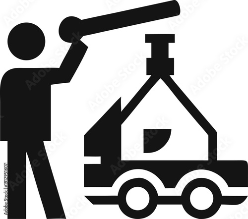 Worker operates machinery for moving a large house structure on a transport vehicle