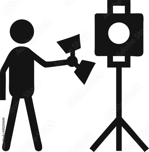 Professional Lighting Crew Member Arranging Multiple Studio Lights for a Filming or Photography Session