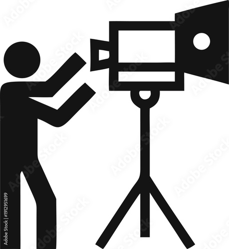 Film Production Lighting Setup Showing a Silhouette Adjusting a Fresnel Studio Lamp on a Stable Tripod