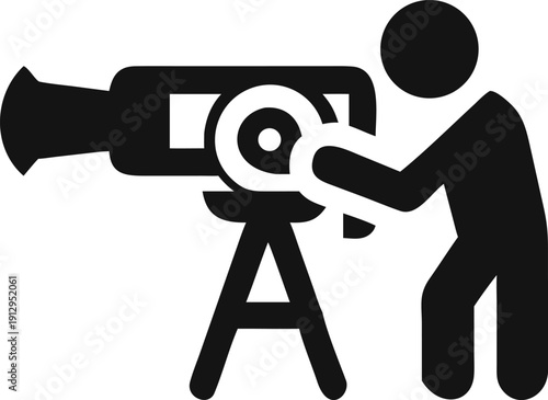 Professional filmmaker adjusting a large video camera mounted on a tripod during a film production