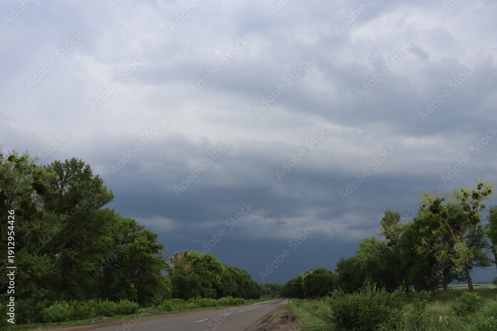 Fototapeta premium Empty road under dramatic storm clouds