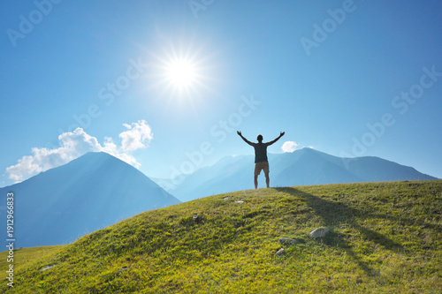 Man on green hill of mountain at daylight.
