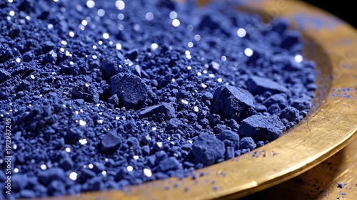 Vibrant Ultramarine Pigment Powder in a Golden Bowl with Sparkling Light Reflections Macro Shot
