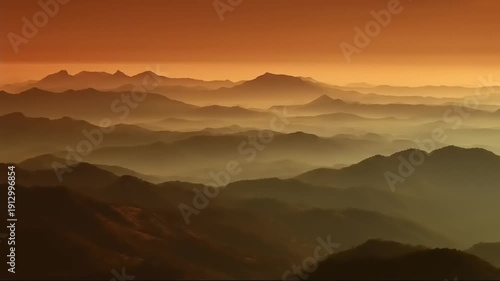 Wallpaper Mural A hazy, mountainous landscape under an orange sky, creating a layered, atmospheric vista Torontodigital.ca