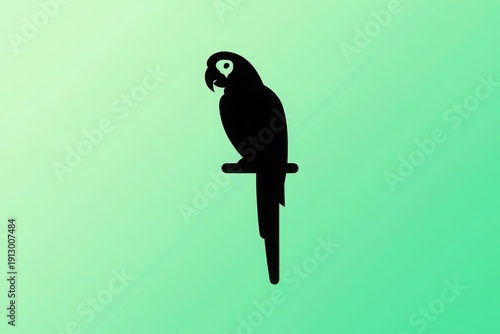Elegant black parrot perched on a simple branch against a vibrant green backdrop