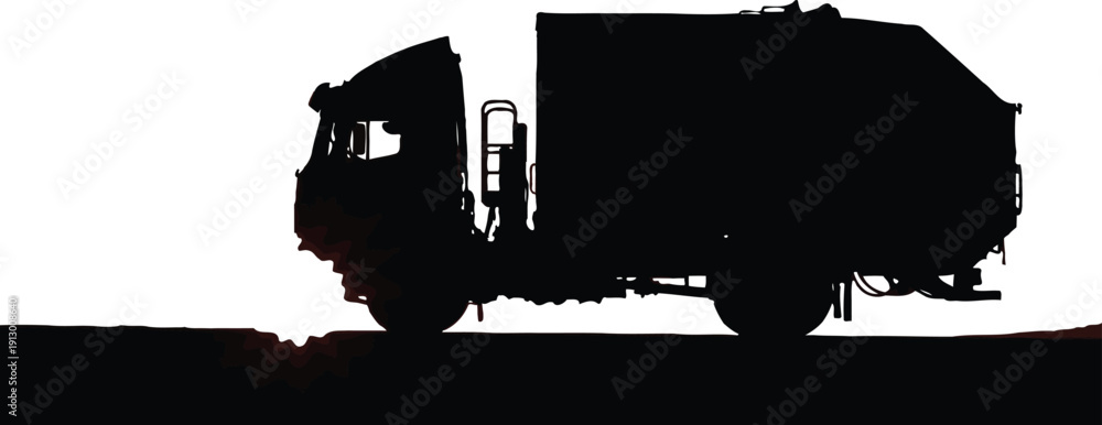 Obraz premium Large refuse truck silhouette drives along a textured, dark road surface under a brilliant white sky.