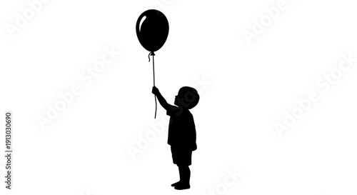 Silhouette of a boy holding a balloon.