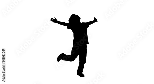 Silhouette of a Happy Child Jumping Freely.