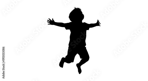Silhouette of a Happy Child Jumping Freely.
