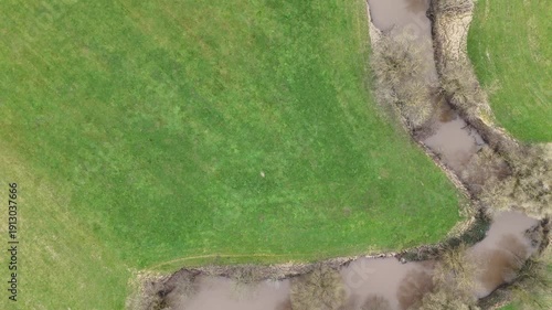 Aerial Drone Flight Along a Winding River Through Rural Farmland	