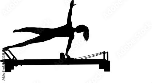 A woman performing a pilates exercise on a reformer machine in a challenging side plank position with one arm and leg extended