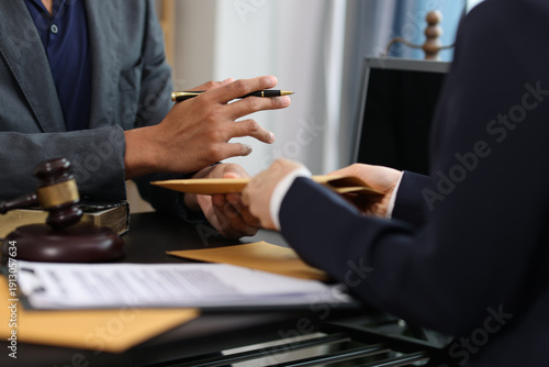 Принти на полотні Lawyer giving important documents to client in office meeting.
