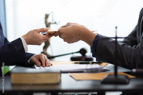 Fotografija Businessman receiving bribe money in brown envelope from businesswoman at office