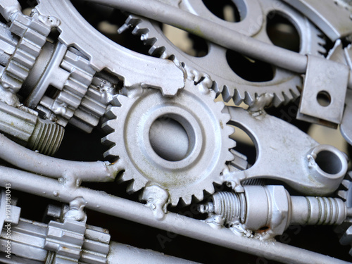 Silver gears and other car parts, repurposed and beautifully displayed.