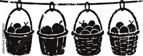 Four vintage baskets filled with fruit hanging on a clothesline in silhouette