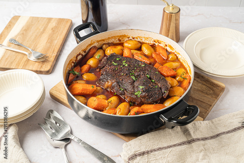 Фотография Hearty food. Beef pot roast with roasted vegetables