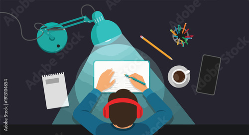 Overhead view of a person wearing headphones, drawing on a tablet under a desk lamp, with coffee and phone nearby.