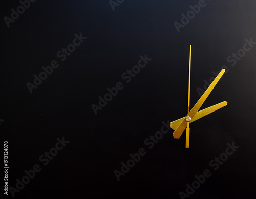 Golden Clock Hands on Black Background