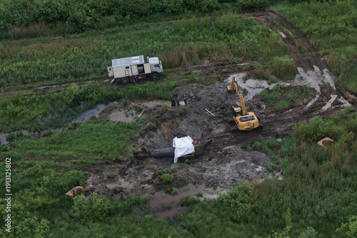 Excavation of damaged pipeline with excavator