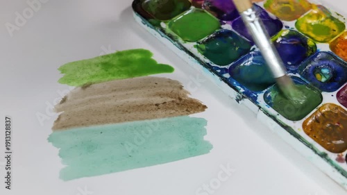 Watercolor Painting Process With Brush Strokes And Color Palette On Paper
