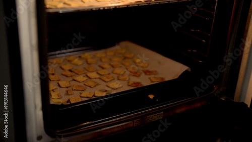Freshly Cut Homemade Christmas Cookies on Baking Sheet Inside a Warm Oven