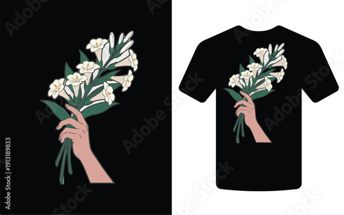 A hand delicately holds a bouquet of white flowers displayed on a black t shirt mockup high quality