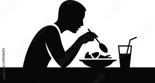 Man eating a meal at a table with a drink, depicted as a black silhouette