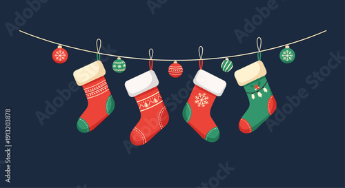 Christmas decoration concept with festive red and green socks and shiny baubles hanging on a thin string over dark background.