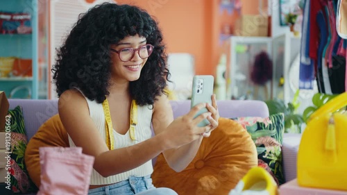 Beautiful young hispanic woman managing her home clothing e-commerce business from home - Female designer owns online shopping store, concepts of home business and reselling second hand accessories