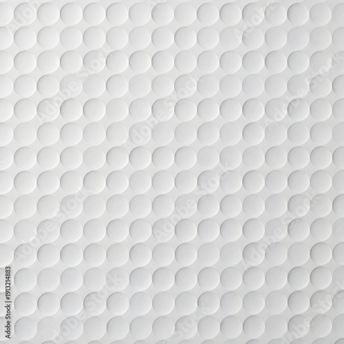 Textured surface of a golf ball with dimples, creating a repeating pattern of circles