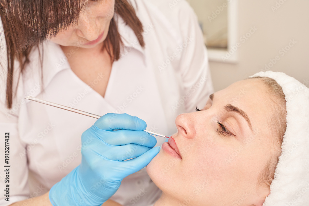 Naklejka premium Female caucasian adult undergoing cosmetic skin procedure in spa setting with focus on beauty and care.